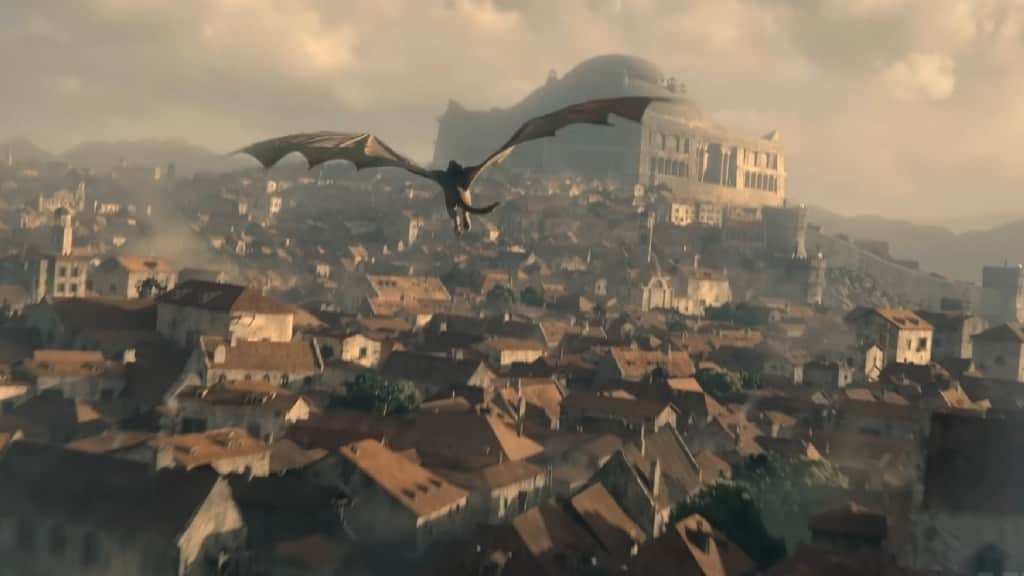Un dragon volant au-dessus d’une ville médiévale dominée par une forteresse brumeuse